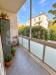 Appartamento in vendita con posto auto coperto a Modena - 10, Balcone urbano con piante e vista verde.png