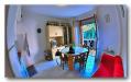 Appartamento bilocale in vendita con terrazzo a Porto Azzurro - 03, salotto con terrazza vicino al mare